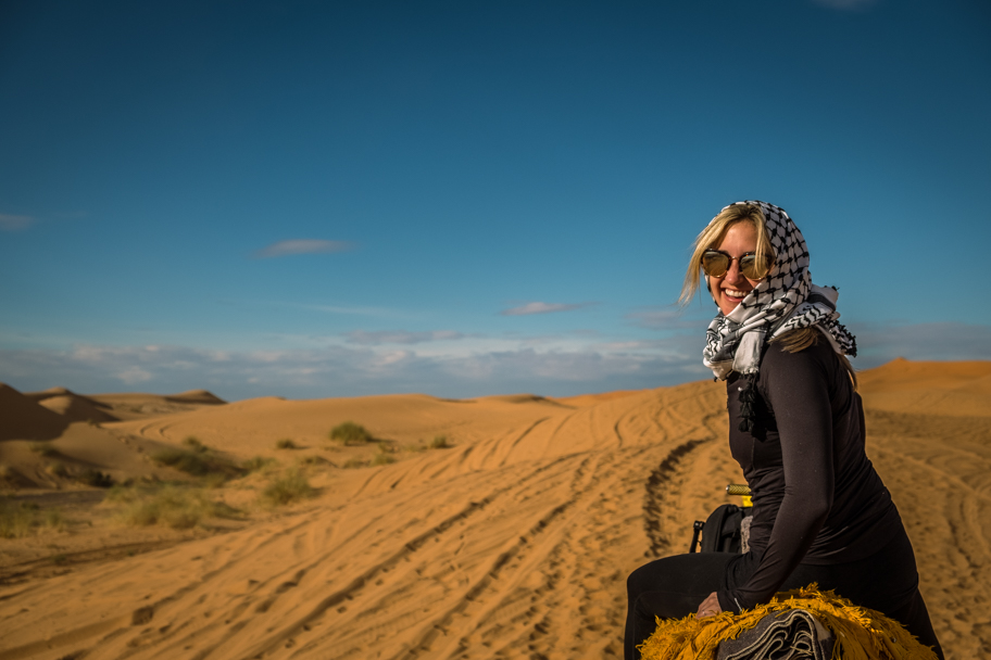 Female tourist on a camel trek in the Sahara Desert, Morocco | Barbara Cameron Pix | Food & Travel Photographer