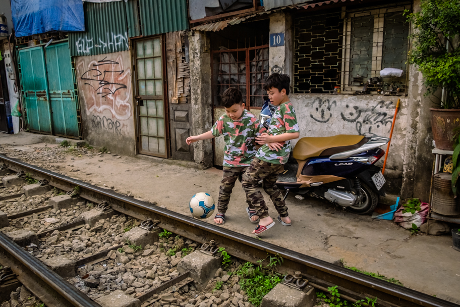 Local boys play soccer on Train Street, Hanoi, Vietnam | Barbara Cameron Pix | Food & Travel Photographer